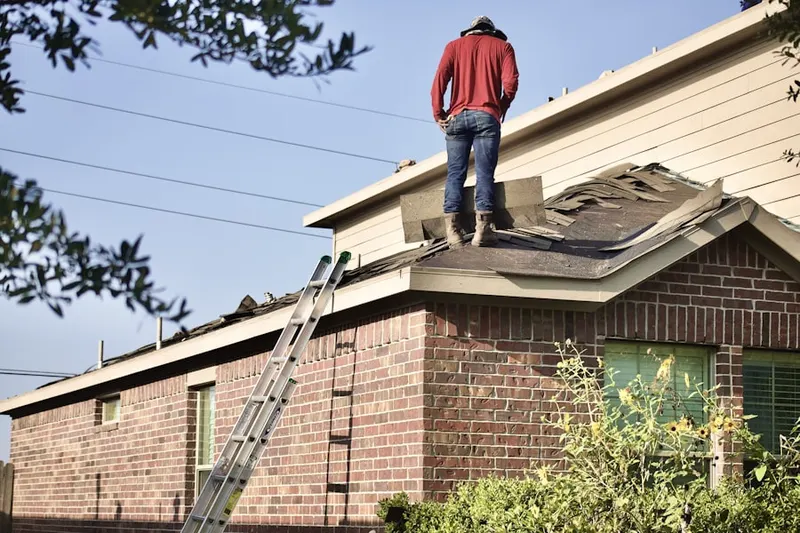 Professional roofer working on a residential roof in Laguna Stonelake